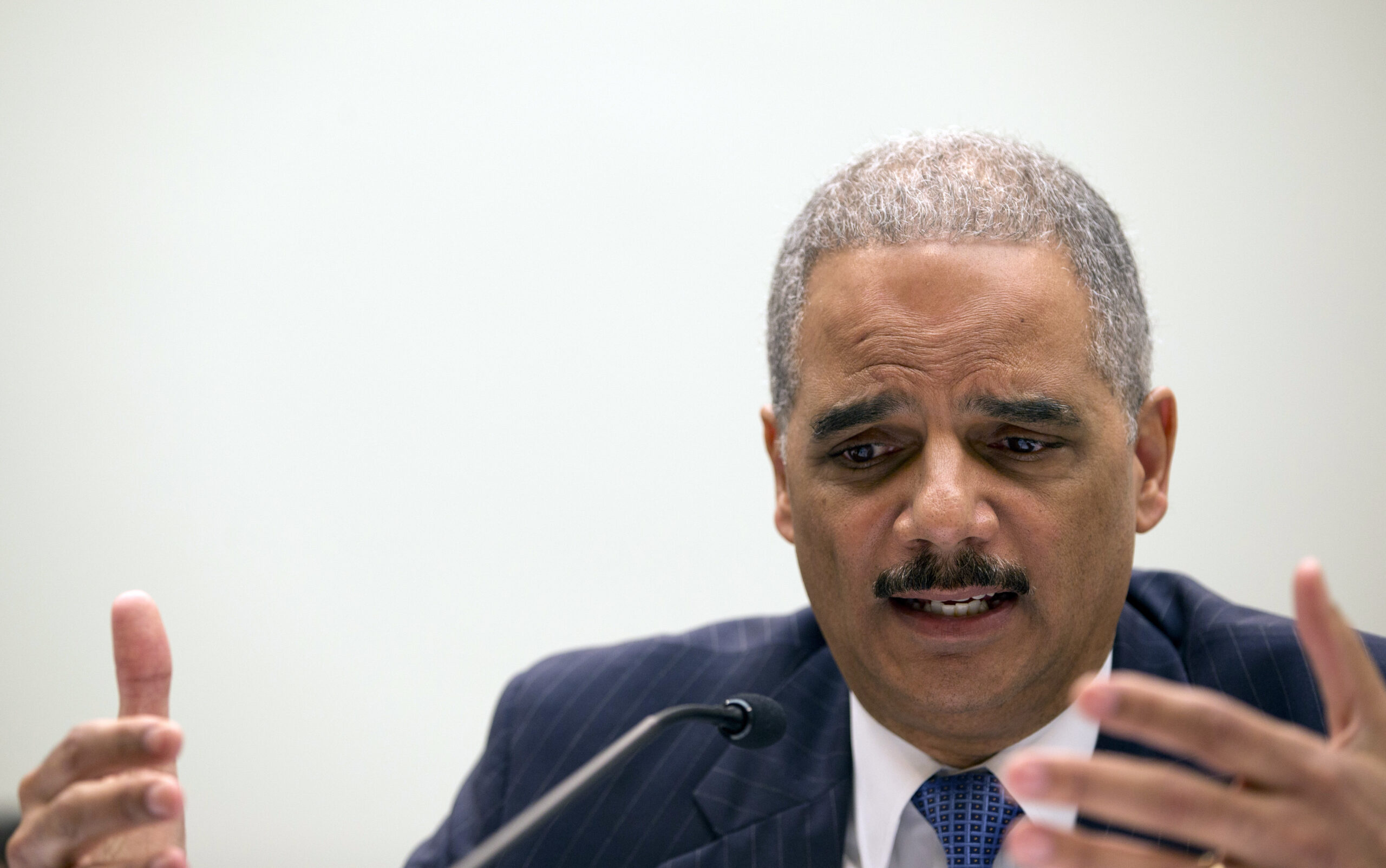 There stands Eric Holder, blocking the schoolhouse door