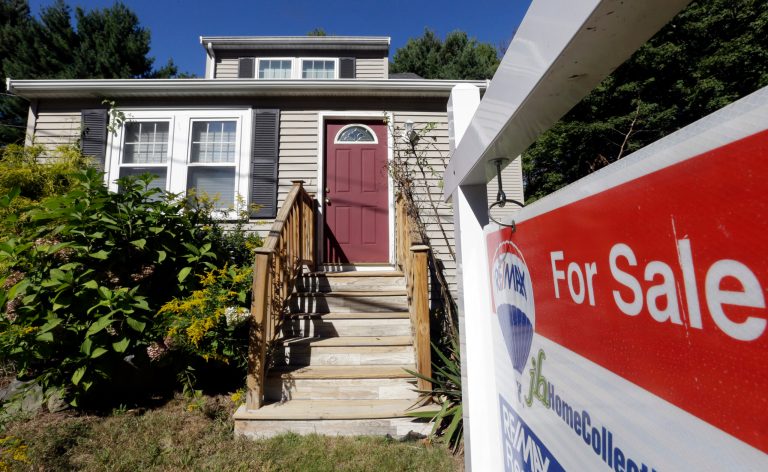 In this Wednesday, Sept. 18, 2013 photo a for sale sign hangs in front of a house in Walpole, Mass.  Freddie Mac reports on mortgage rates for this week Thursday Oct. 24, 2013.  (AP Photo/Steven Senne)