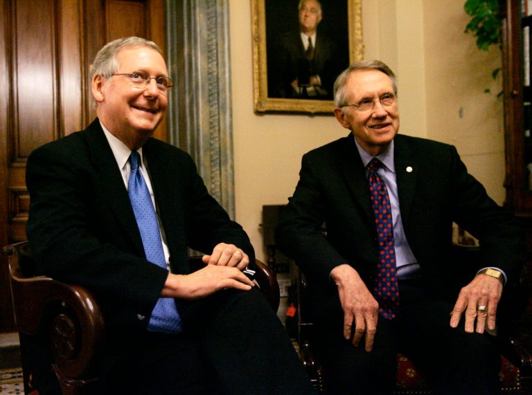 Mitch McConnell, left, blamed the hold up on Senate Majority Leader Harry Reid, D-Nev., and President Obama, who he said are insisting tax reform produce $1 trillion in new revenue. (AP Photo)