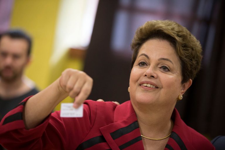 Brazil's President Dilma Rousseff, who is running for re-election with the Workers Party (PT), shows her electronic voting receipt that confirms that she voted in general elections in Porto Alegre, Brazil, Sunday. Brazilians are casting ballots in an election expected to force a three-week runoff campaign between incumbent Rousseff and one of her two top challengers, either former environment minister and senator Marina Silva or Aecio Neves. Brazilians are also deciding congressional races and electing governors. (AP Photo/Felipe Dana)