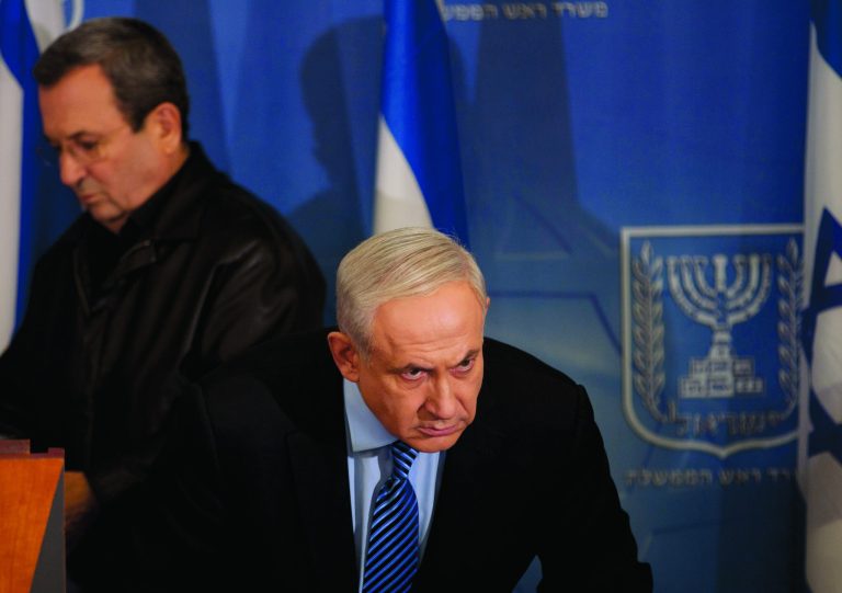 Israel's Prime Minister Benjamin Netanyahu looks on as Israel's Defense Minister Ehud Barak, left, goes to deliver a statement to the media at Hakirya a military base in Tel Aviv, Israel, Wednesday, Nov. 14, 2012. Israel's prime minister says the military is prepared to broaden its operation against Hamas targets in Gaza. Benjamin Netanyahu says Israel cannot tolerate continued rocket attacks against its citizens. In his first comments since Israel killed the commander of the Hamas military wing, Netanyahu said Wednesday that Israel is 