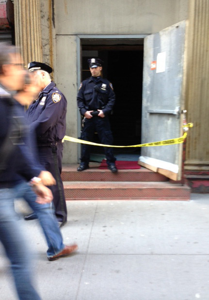 Crime scene tape and a New York City police officer block the service entrance to the site of a proposed Islamic community center in New York City, after a 5-foot-tall piece of landing gear has been discovered wedged between it and a luxury high-rise apartment building, Friday, April 26, 2013. The wreckage is believed to be from one of the hijacked planes destroyed in the Sept. 11, 2001 terrorist attacks on the World Trade Center. (AP Photo/Tom Hays)