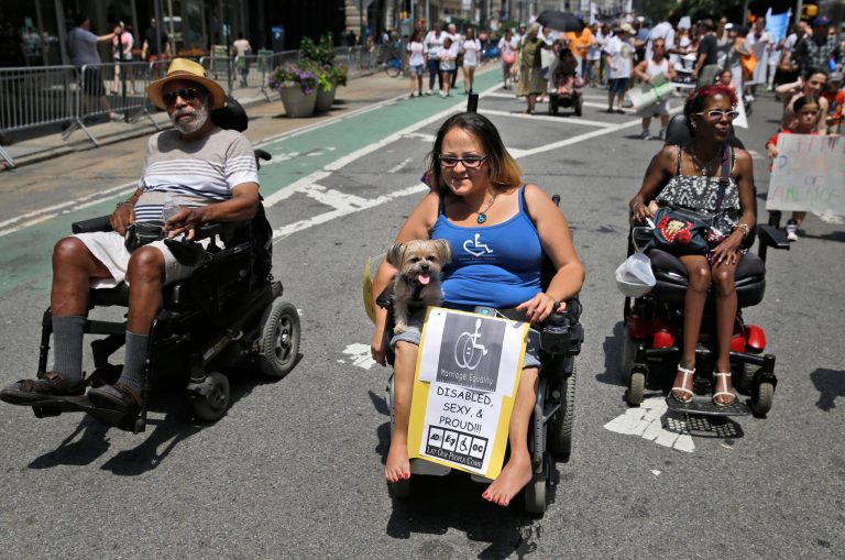 Jessica Delarosa, center, and her dog Mayim participate in the inaugural Disability Pride Parade, Sunday, July 12, 2015, in New York. (AP Photo)Â 