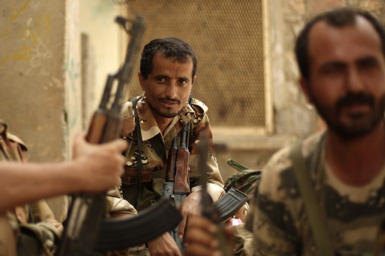   A Yemeni army soldier, center, looks on as he sits with his comrades at their post in the town of Jaar in southern Abyan province, Yemen, Friday, June 15, 2012. Yemen says government troops have killed scores of militants in a push to rout al-Qaida fighters from the last town under militant control in the southern Abyan province. (AP Photo/Hani Mohammed)  