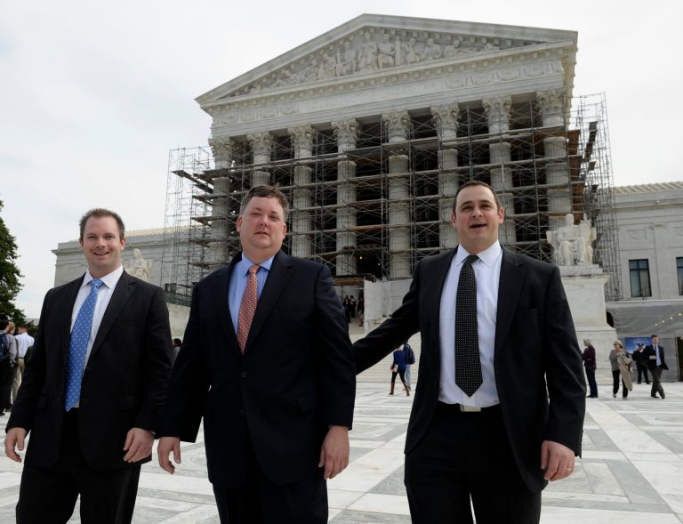 Republican activist Shaun McCutcheon of Hoover, Ala., center, leaves the Supreme Court after the court's hearing on campaign finance. The court is tackling a challenge to limits on contributions by the biggest individual donors to political campaigns. McCutcheon, the national Republican Party and Senate Minority Leader Mitch McConnell of Kentucky want the court to overturn the overall limits on what contributors may give in a two-year federal election cycle. (AP Photo/Susan Walsh)