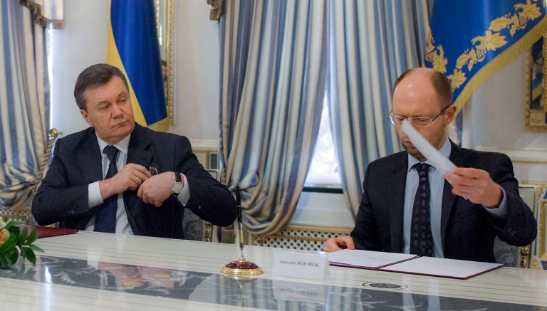 Ukrainian President Viktor Yanukovych, left, and Ukrainian opposition leader Arseniy Yatsenyuk attend a signing ceremony of the agreement in Kiev, Ukraine, Friday, Feb. 21, 2014. Ukraine's opposition leaders signed a deal Friday with the president and European mediators for early elections and a new government in hopes of ending a deadly political crisis. Russian officials immediately criticized the deal and protesters angry over police violence showed no sign of abandoning their camp in central Kiev. (AP Photo/Andrei Mosienko, Presidential Press Service, Pool)