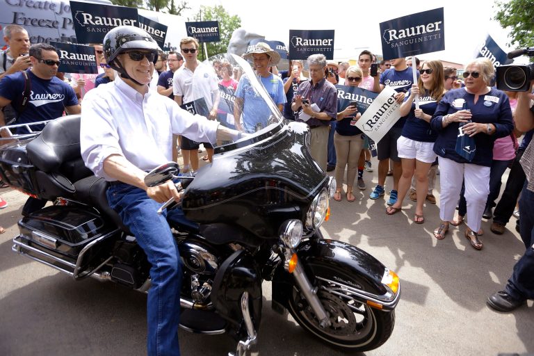 Illinois Republican gubernatorial candidate Bruce Rauner rides his Harley-Davidson motorcycle into the Illinois State Fairgrounds before participating in a Republican Day rally at the State Fair, Thursday, Aug. 14, 2014, in Springfield, Ill.  (AP Photo/Seth Perlman)