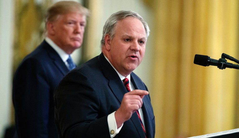 In this July 8, 2019 file photo President Donald Trump listens as Secretary of the Interior David Bernhardt speaks during an event on the environment in the East Room of the White House in Washington. A congressional committee is investigating whether the U.S. Interior Department helped an Arizona developer and supporter of President Donald Trump get a crucial permit. U.S. Rep. RaÃºl Grijalva is leading an investigation into the proposed 28,000-home development.