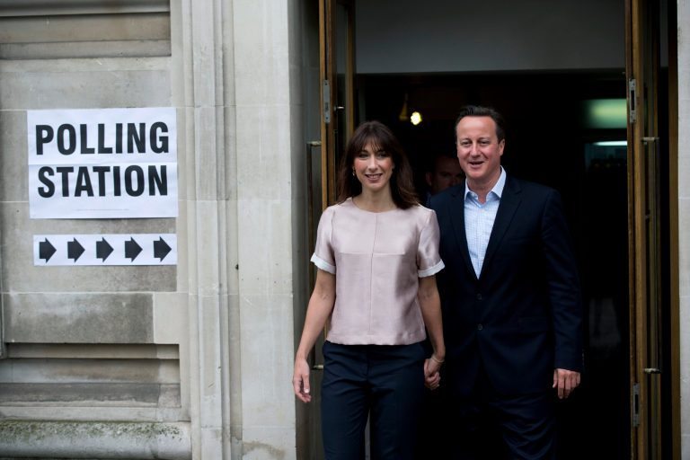 Britain's Prime Minister and leader of the Conservative Party David Cameron and his wife Samantha pause to pose for photographers and television cameras as they leave after casting their votes at a polling station in central London, Thursday, May 22, 2014.  Voters in 28 countries on Thursday begin choosing the next European Parliament and helping determine the EU's future leaders and course.  Around 400 million Europeans are eligible to take part in what is termed the world's largest cross-border exercise in representative democracy.  (AP Photo/Matt Dunham)