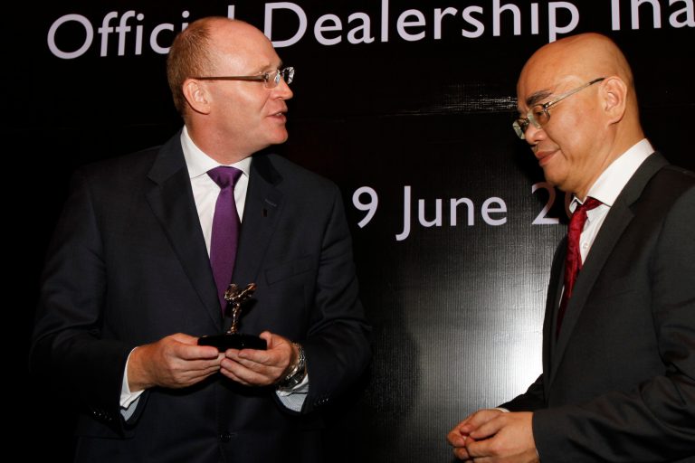 Rolls-Royce Asia-Pacific regional manager Paul Harris, left, speaks to HGB Group Co. Ltd. managing director Ray Long during the inauguration of Rolls-Royce's official dealership in Phnom Penh, Cambodia, Monday, June 9, 2014. Rolls-Royce Motor Cars announced Monday that it has joined with the Cambodian business partner HGB to open a showroom in the Cambodian capital next month. (AP Photo/Heng Sinith)
