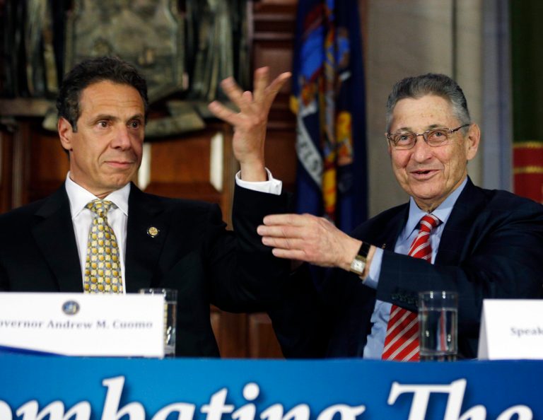 Assembly Speaker Sheldon Silver, D-Manhattan, right, raises Gov. Andrew Cuomo's arm after Cuomo said he is pliable during a news conference in the Red Room at the Capitol on Wednesday, June 18, 2014, in Albany, N.Y. (AP Photo/Mike Groll)