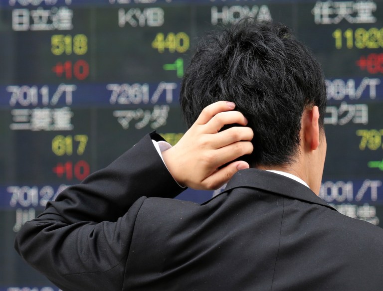 A man looks at an electronic stock board of a securities firm in Tokyo, Tuesday, June 3, 2014. Japan's Nikkei 225, the regional heavyweight, rose 0.9 percent to 15,068.12. Japanese shares have been boosted recently by renewed weakness in the yen and expectations the country's giant government pension fund will increase its holdings of shares at the expense of bonds. (AP Photo/Koji Sasahara)