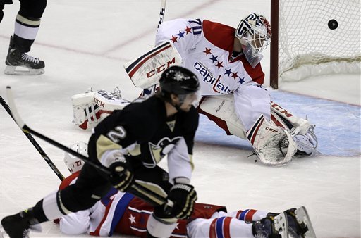 Pittsburgh Penguins defenseman Matt Niskanen (2) puts the puck behind Washington Capitals goalie Braden Holtby (70) and Washington Capitals defenseman Karl Alzner (27) for a game-winning goal in the third-period. (AP Photo/Gene J. Puskar)
