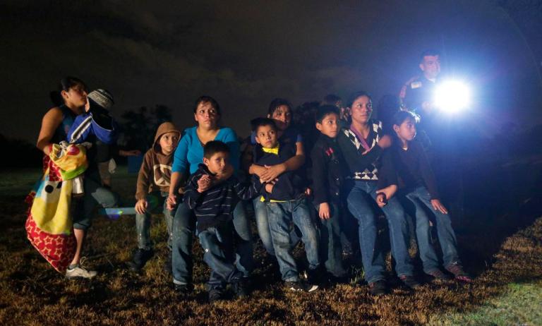 Immigrants from Honduras and El Salvador crossing the U.S.-Mexico border illegally. (AP Photo/Eric Gay)