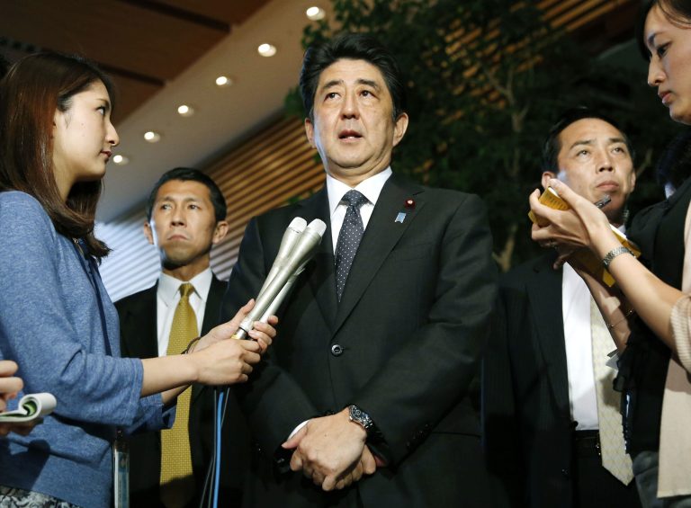 Japanese Prime Minister Shinzo Abe, center, speaks to the media about a three-day talks with North Korea in Stockholm at the prime minister's official residence in Tokyo Thursday, May 29, 2014. North Korea has agreed to open a new investigation into the fate of Japanese citizens whom it abducted in the 1970s and 1980s, Japan and North Korea said Thursday. Abe said the agreement was just a first step toward resolving the kidnapping issue that has long kept the nations at odds. (AP Photo/Kyodo News) JAPAN OUT, CREDIT MANDATORY