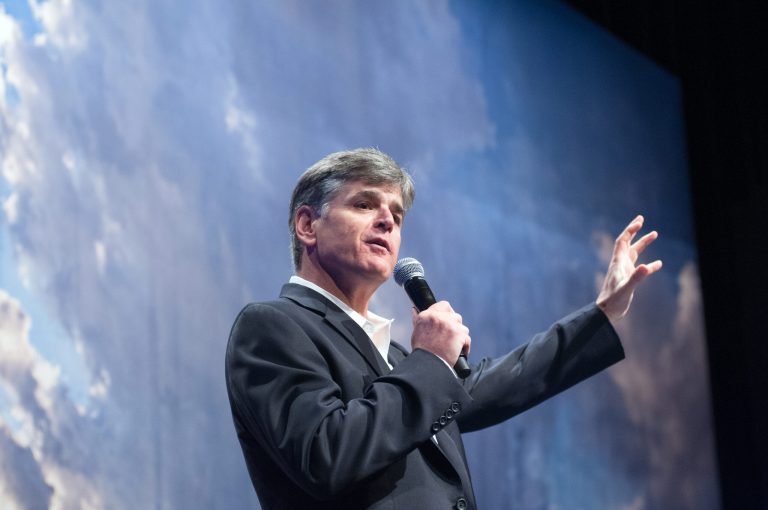 Political commentator Sean Hannity addresses the crowd while delivering a speech last year in Bismarck, N.D. (AP Photo/Kevin Cederstrom)