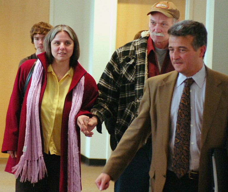 FILE - In this Feb. 28, 2008 file photo, Lynn Dejac Peters, left, and her husband, Chuck Peters, hold hands after her murder conviction was overturned in State Supreme Court in Buffalo, N.Y. She served 13 years for the 1993 murder of her daughter, Crystallynn Girard. Lynn DeJac Peters died at her Buffalo home, Wednesday June 18, 2014. She was 50. (AP Photo/Don Heupel, File)