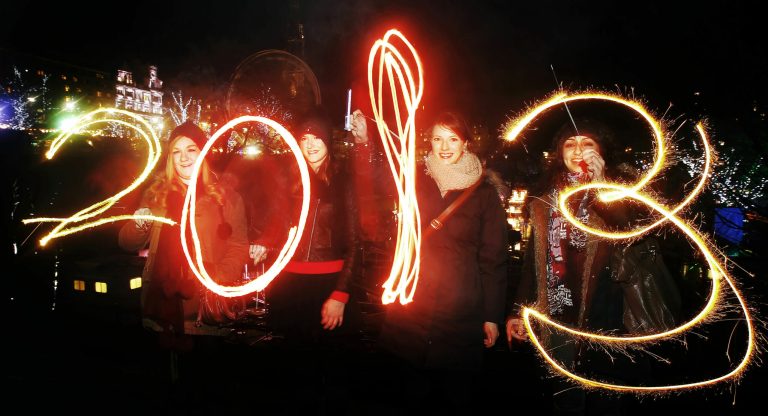   Katy Saunders, left, Alex Mueller, center left, Rebekka Frank and Arina Motamedi, right, play with sparklers ahead of welcoming in the new year during the 2013 Edinburgh Hogmanay celebrations, Scotland, Monday December 31, 2012. See PA story SOCIAL NewYear. (AP Photo/PA,Danny Lawson)UNITED KINGDOM OUT   