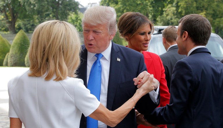 French President Emmanuel Macron, right, welcomes First Lady Melania Trump as his wife Brigitte, left, welcomes President Trump at Les Invalides museum in Paris Thursday, July 13, 2017. (AP Photo/Michel Euler)