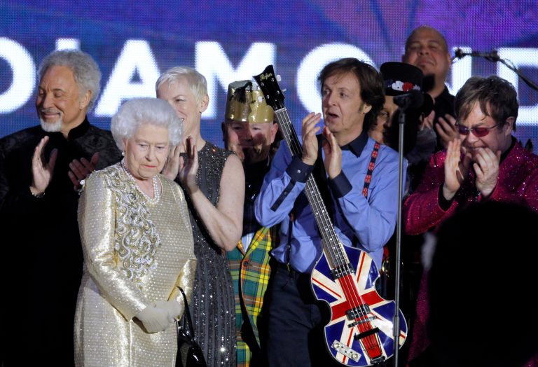   FILE - In this Monday, June 4, 2012 file photo, Britain's Queen Elizabeth II, 2nd from left, is joined on stage by performers Sir Tom Jones, Annie Lennox, Sir Paul McCartney and Sir Elton John at the conclusion of the Queen's Jubilee Concert in front of Buckingham Palace, London. McCartney turned 70 years of age Monday June 18, 2012. (AP Photo/Joel Ryan)  