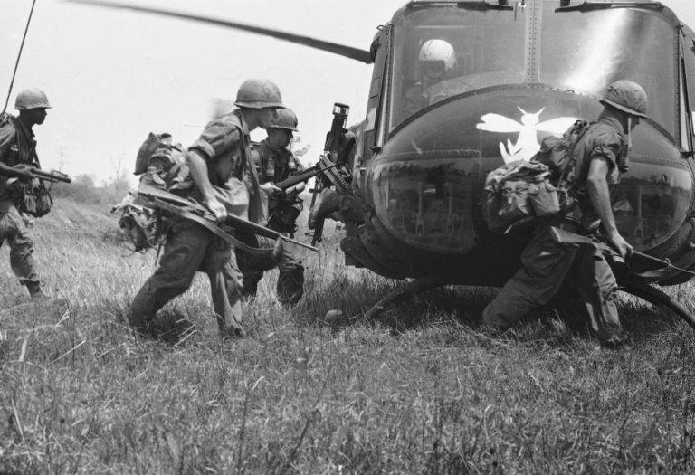 U.S. paratroopers dash across clearing to helicopters that will lift them out of this section of jungle in War Zone C in Vietnam in March 1967 and drop them in another to continue their pursuit of the Viet Cong along the Cambodian border.