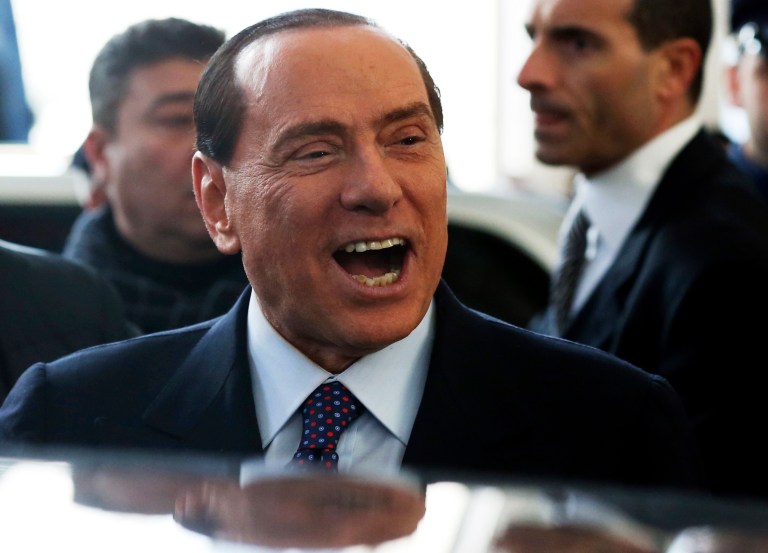   Former Italian premier Silvio Berlusconi smiles as he arrives at Milan's central train station, Italy, Saturday, Dec. 29, 2012. Italian Premier Mario Monti announced Friday he is heading a new campaign coalition made of up centrists, business leaders and pro-Vatican forces who back his 