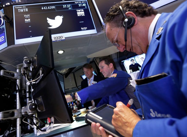 Trader Steven Kaplan, right, works at the post that handles Twitter, on the floor of the New York Stock Exchange, Wednesday, April 30, 2014.  Shares of Twitter dropped in morning trading Wednesday to their lowest point since the company went public in November. Investor concern remains over the short messaging service's ability to keep adding users and keep existing users engaged. (AP Photo)