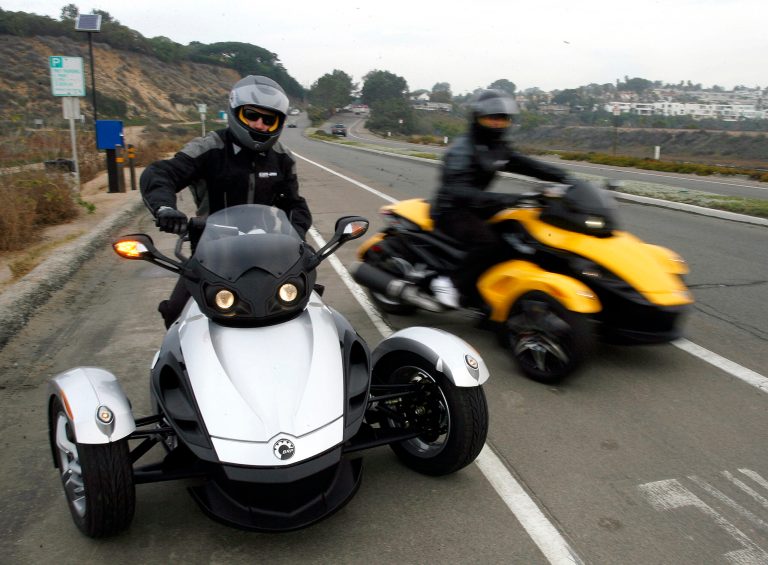 In this Feb. 9 2007 file photo provided by Can-Am Spyder, test riders pull out onto the highway for a test ride at the unveiling of the 2008 Can-Am Spyder roadster in Del Mar, Calif. U.S. safety regulators are investigating two reports of fires in Can-Am Spyder three-wheeled motorcycles. The probe announced Friday, Aug. 8, 2014 covers about 52,000 motorcycles from the 2008 through 2014 model year. (AP Photo/Can-Am Spyder, Denis Poroy, File)