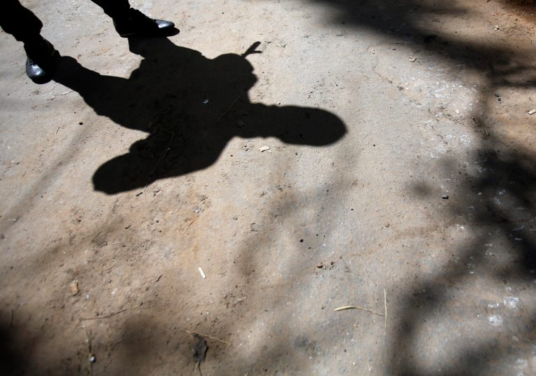 The shadow of an armed pro-Russian man while guarding the local administration building in the center of Slovyansk, eastern Ukraine, Tuesday, May 6, 2014.   Interior Minister Arsen Avakov gave the death toll on his Facebook page Tuesday, adding that 20 government troops were also injured during fighting in Slovyansk, a city of 125,000, without making clear when the deaths took place.  Gun battles erupted around the city Monday as the interim government tries to quell weeks of unrest in Ukraine's mainly Russian-speaking east.  (AP Photo/Darko Vojinovic)