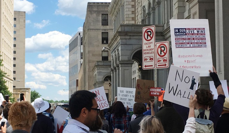In this photo, people protest outside the federal courthouse in Richmond, Va., Monday, May 8, 2017. Once again, a version of President Trump's travel ban will be argued over in the 4th Circuit Court of Appeals after a Maryland judge in October blocked the new guidance issued by the Trump administration in September. (AP Photo/Steve McMillan)