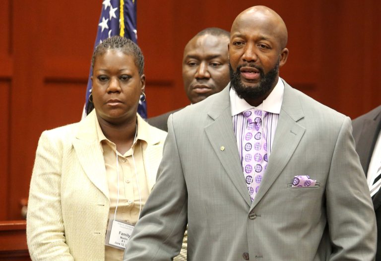 Tracy Martin, right, and Sybrina Fulton, the parents of slain teen Trayvon Martin, make a statement to reporters during a news conference at the Seminole County Courthouse, in Sanford, Fla., Wednesday, June 12, 2013. In the background is their attorney Benjamin Crump. (AP Photo/Orlando Sentinel, Joe Burbank, Pool)