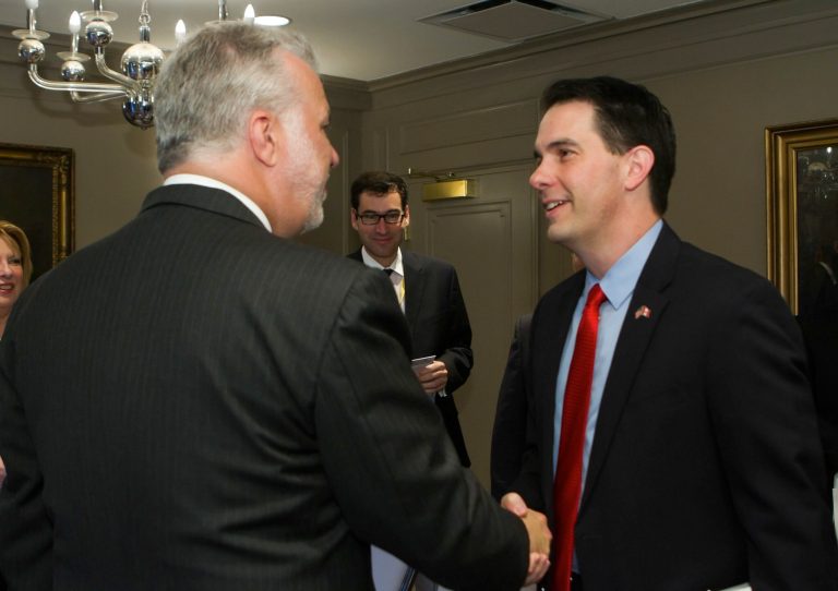 Quebec Premier Philippe Couillard shakes hands with Wisconsin Governor Scott Walker, right, at the Council of Great Lakes Governors 2015 Leadership Summit Saturday, June 13, 2015 in Quebec City, Canada. (Clement Allard/The Canadian Press via AP)
