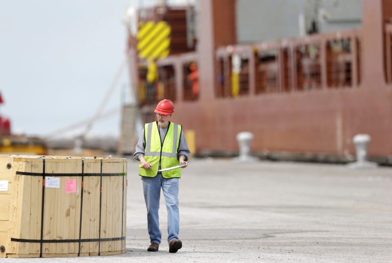 In this Monday, April 21, 2014 photo, a worker inspects a crate that will be loaded on the Amsterdam-bound Fortunagracht at the Port of Cleveland in Cleveland. The Commerce Department releases international trade data for May on Thursday, July 3, 2014. (AP Photo/Tony Dejak)