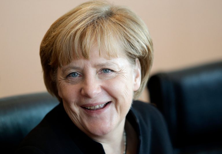 German Chancellor Angela Merkel smiles as she arrives for the weekly cabinet meeting at the chancellery in Berlin, Germany, Wednesday, Aug. 20, 2014. (AP Photo/Michael Sohn)