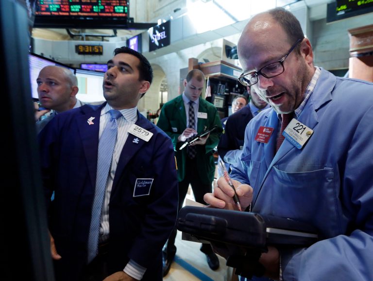 Specialist William Geier, second left, works with traders at the post that handles Hillshire Brands, on the floor of the New York Stock Exchange Tuesday, May 27, 2014. Hillshire Brands, the maker of Jimmy Dean breakfast sausage, jumped 22 percent after poultry producer Pilgrim's Pride offered to acquire the company. (AP Photo/Richard Drew)