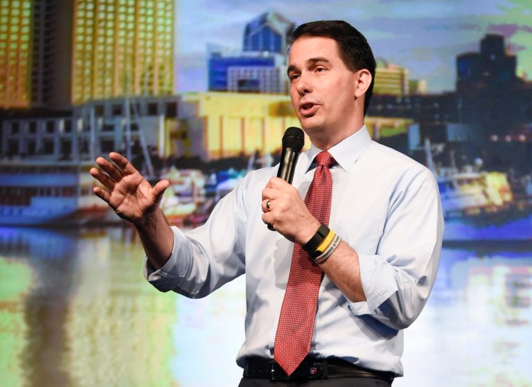 At this point, Donald Trump's hat will generate more media coverage than any policy pronouncement of Scott Walker's. (AP Photo)