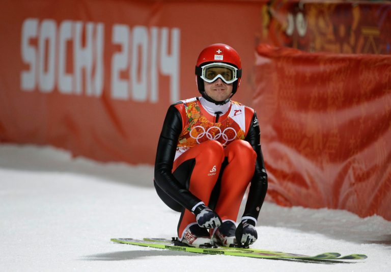Switzerland's Simon Ammann checks the scoreboard during the men's normal hill ski jumping qualification at the 2014 Winter Olympics on Saturday in Krasnaya Polyana, Russia. (AP Photo/Gregorio Borgia)
