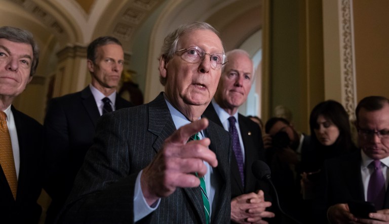 Senate Majority Leader Mitch McConnell, R-Ky., (pictured center) told fellow Republicans not to leave town in a closed-door session on Thursday as congressional Republicans attempt to pass a temporary spending bill. (AP Photo/J. Scott Applewhite)