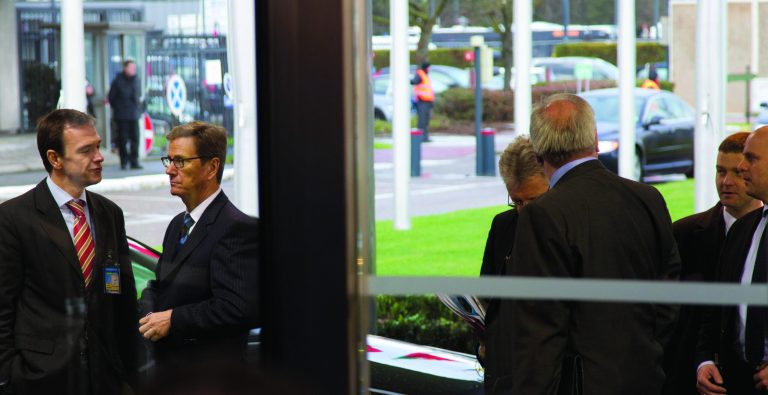 German Foreign Minister Guido Westerwelle, second left, speaks with an unidentified member of his delegation as he arrives for a meeting of NATO foreign ministers at NATO headquarters in Brussels on Tuesday, Dec. 4, 2012. NATO foreign ministers are expected to approve Turkey's request for Patriot anti-missile systems to bolster its defense against possible strikes from neighboring Syria. (AP Photo/Virginia Mayo)