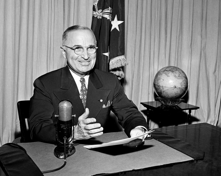 In this Sept. 1, 1945 file photo, then-U.S. President Harry Truman sits before a microphone at the White House in Washington, where he broadcast a message on the formal surrender of Japan. (AP Photo, File)