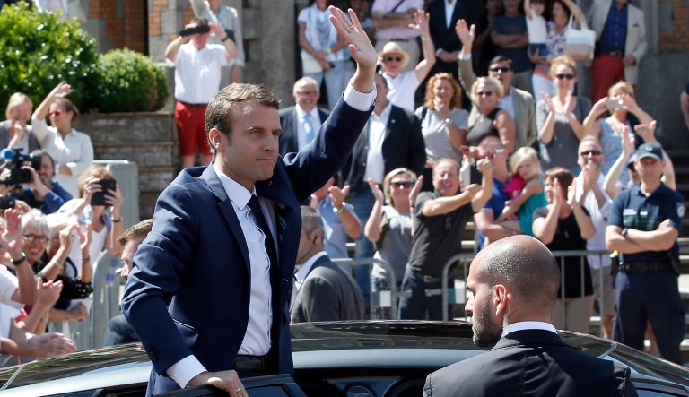 French President Emmanuel Macron waves to the audience as he leaves a polling station in Le Touquet, northern France, after casting his vote in the first round of the two-stage legislative elections, Sunday, June 11, 2017. (AP Photo/Thibault Camus)