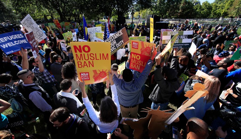 Protesters gather at a rally against the travel ban in front of the White House. The Justice Department Tuesday asked the 4th Circuit Court of Appeals to review the decision by a federal judge in Maryland to block Trump's newest travel restrictions hours before the restrictions were set to begin. (AP Photo/Manuel Balce Ceneta)