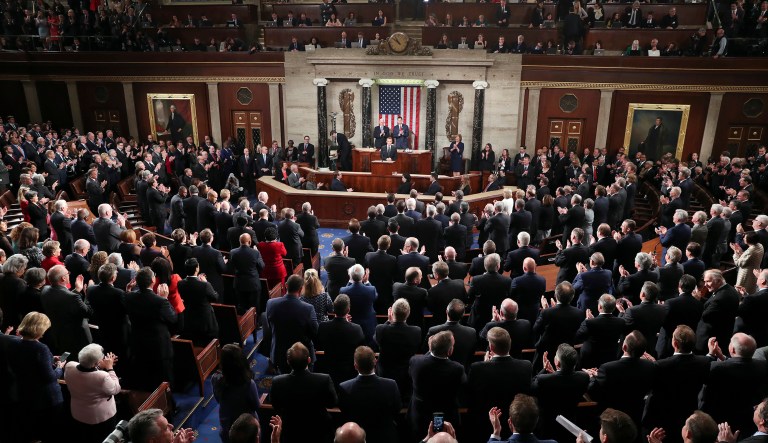 French President Emmanuel Macron pauses as he receives a standing ovation during his address to a joint meeting of Congress on Capitol Hill in Washington, Wednesday, April 25, 2018. Standing behind him are Vice President Mike Pence and House Speaker Paul Ryan of Wis.