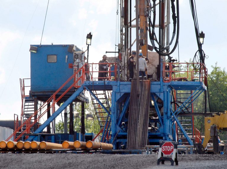 FILE - In this June 25, 2012 file photo, a crew works on a gas drilling rig at a well site for shale based natural gas in Zelienople, Pa. The National Park Service says it is withdrawing 