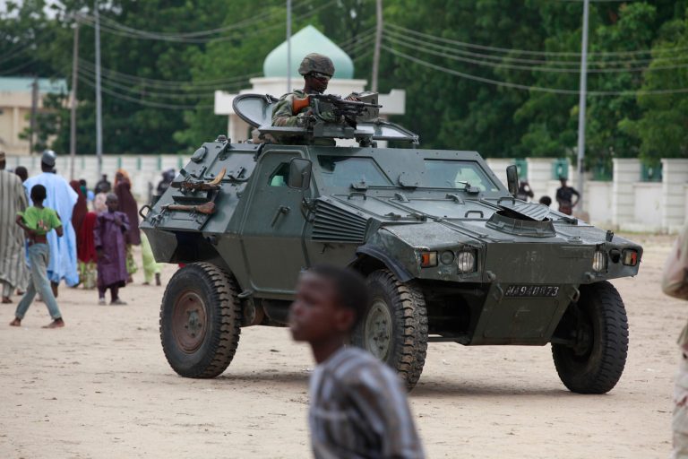 Nigerian soldiers ride on an armored personnel carrier during Eid al-Fitr celebrations in Maiduguri, Nigeria. (AP/Sunday Alamba)