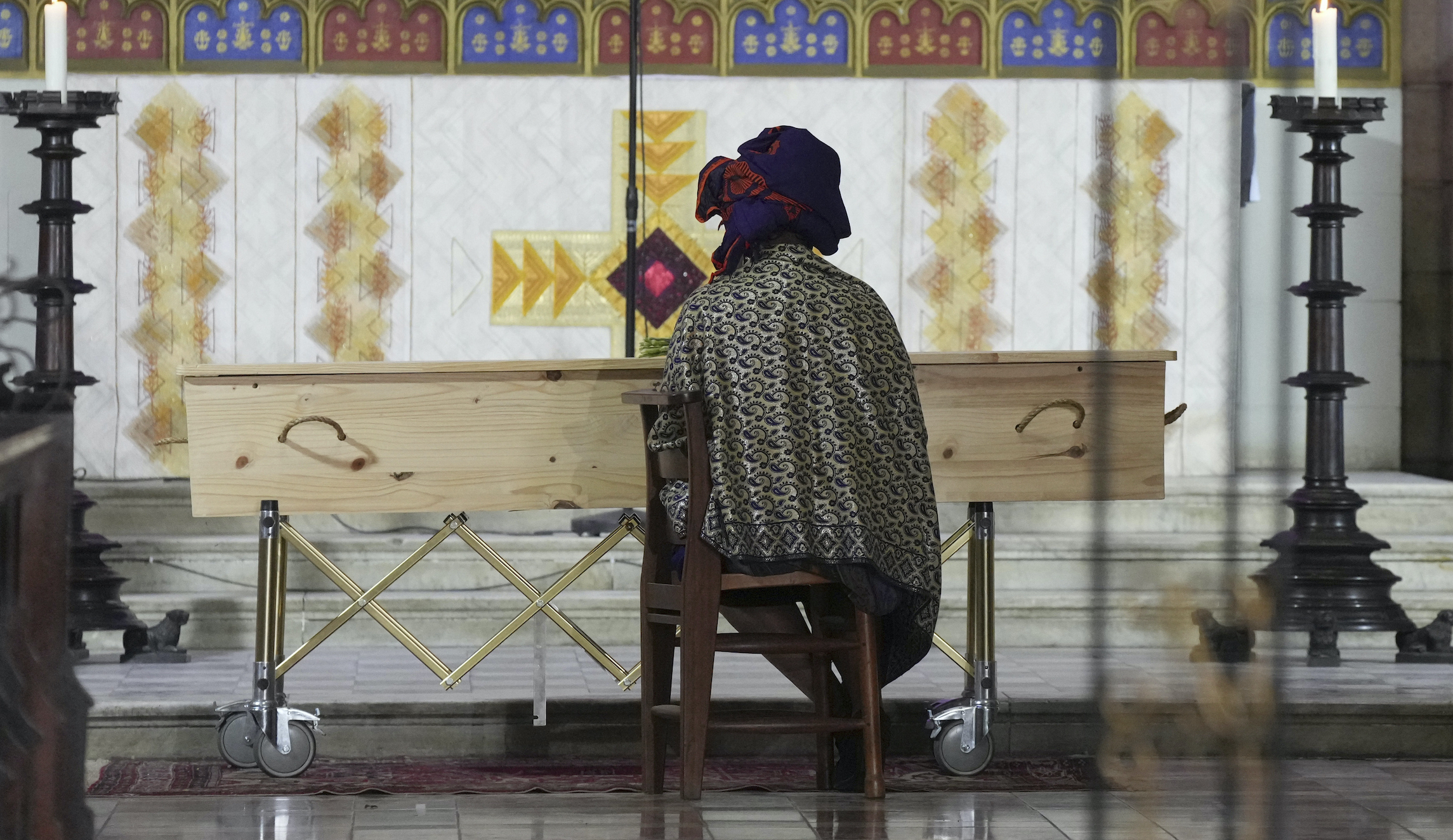 Nontombi Tutu sits with the coffin of her father, Anglican Archbishop Emeritus Desmond Tutu, during his funeral at the St. George's Cathedral in Cape Town, South Africa, on Saturday. He died Sunday at the age of 90.