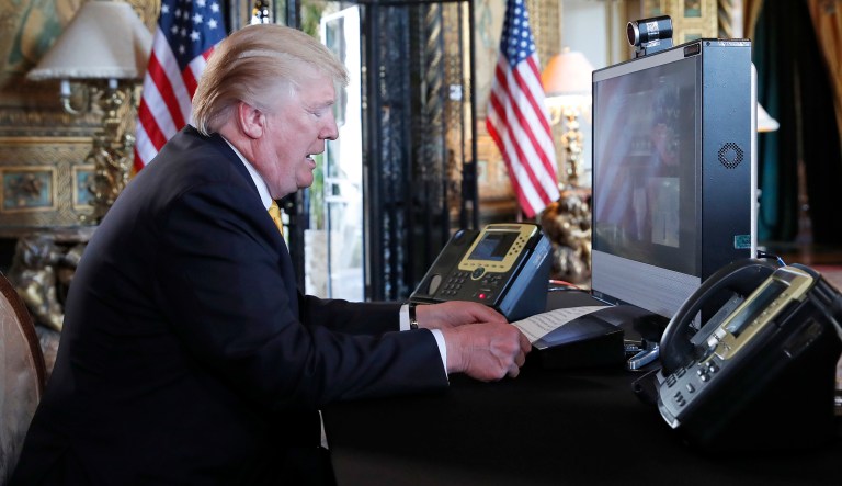 President Donald Trump speaks with members of the armed forces via video conference at his private club, Mar-a-Lago, on Thanksgiving, Thursday, Nov. 23, 2017, in Palm Beach, Fla. (AP Photo/Alex Brandon)