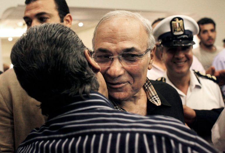   FILE - In this Friday, June 8, 2012 file photo, Egyptian presidential runoff candidate Ahmed Shafiq is greeted by a supporter after attending a press conference in Cairo, Egypt. Shafiq's candidacy has dismayed many Egyptians who believe the veteran figure of Mubarak's regime will only preserve the authoritarianism of his rule. But even if some Christians share those reservations, they view his opponent in the race as far worse: Mohammed Morsi, of the Muslim Brotherhood, which Egypt's Christian minority fears will turn the country into an Islamic state. (AP Photo/Nasser Nasser, File)  