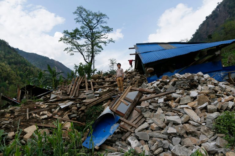 A young boy stands in the center of his collapsed home in the destroyed village of Jalingi, near the epicenter of Saturday's massive earthquake, in the Gorkha District of Nepal, Thursday, April 30, 2015. (AP Photo/Wally Santana)