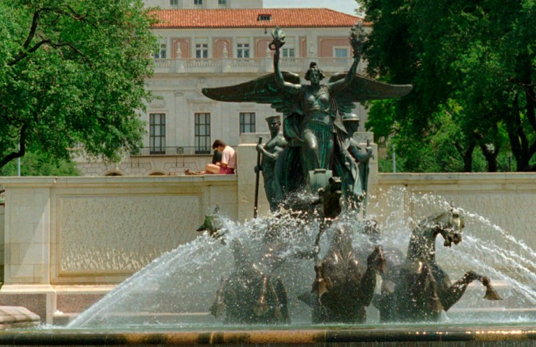 A student reads above the fountain at the University of Texas Monday, July 1, 1996, in Austin, Texas. (AP Photo/Harry Cabluck)